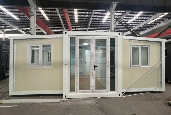 Double-wing expandable container house shown in folded transport position &mdash; Wanbang